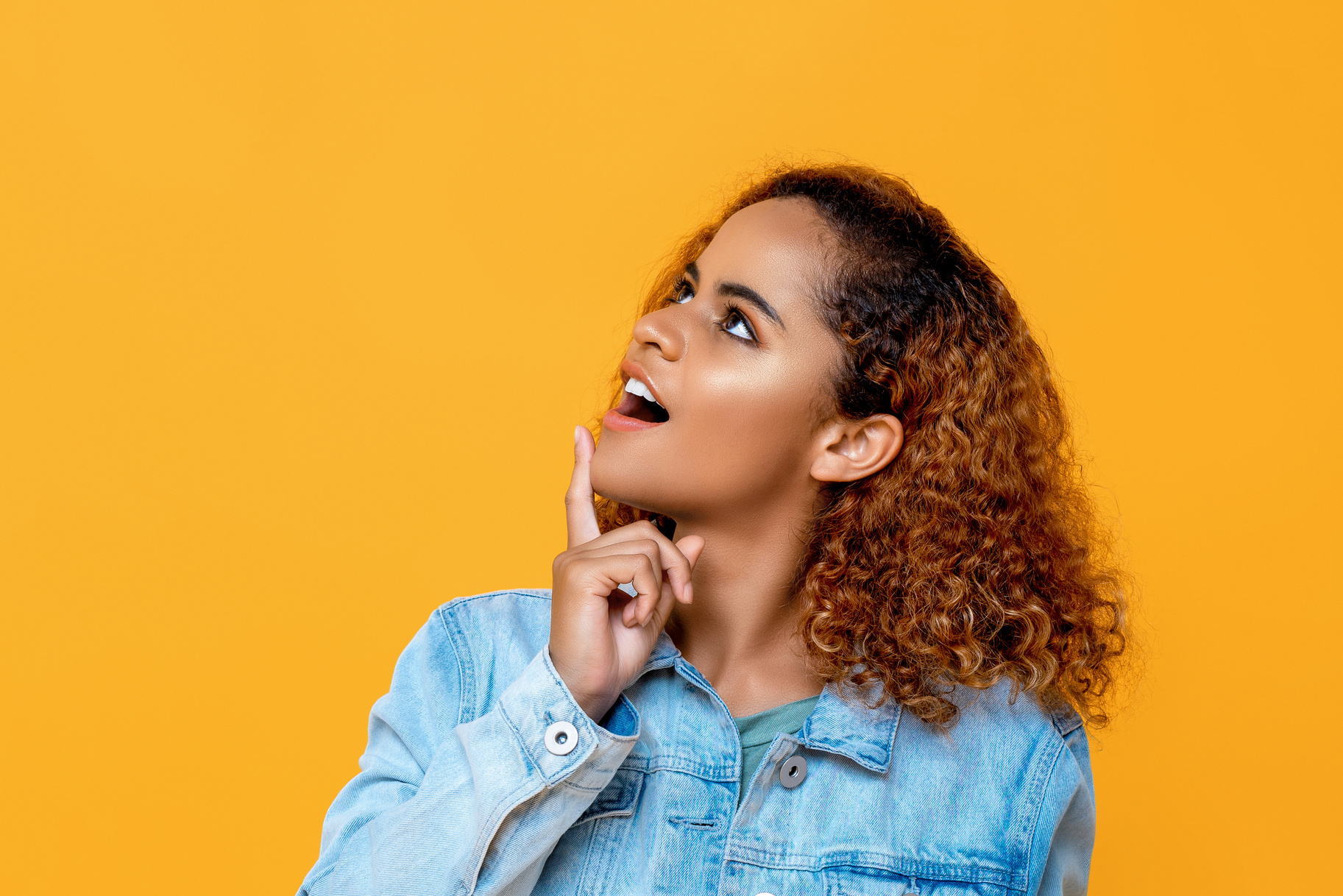Curious African American Woman Looking up Touching Her Chin