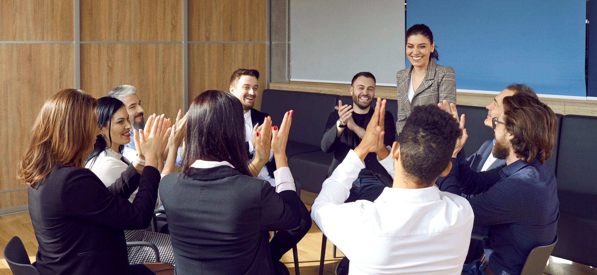 Group of Happy Employees Clapping Hands to Give Recognition to Their Team Leader